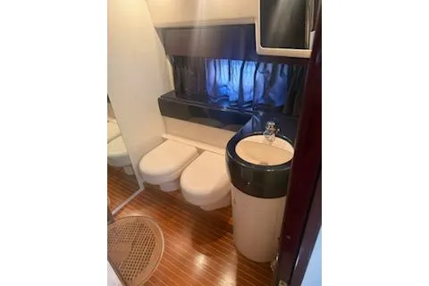 Slide: The Image of Compact bathroom in a 1996 Princess model, featuring a sink and toilet with wood flooring. - 15