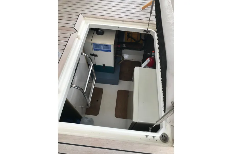Slide: The Image of 1996 Princess boat interior with wooden flooring and storage compartments. - 16