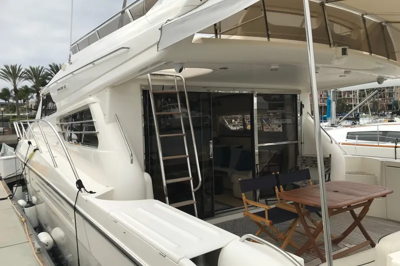 Slide: The Image of Luxury 1996 Princess yacht docked, featuring outdoor seating and sleek design. - 18