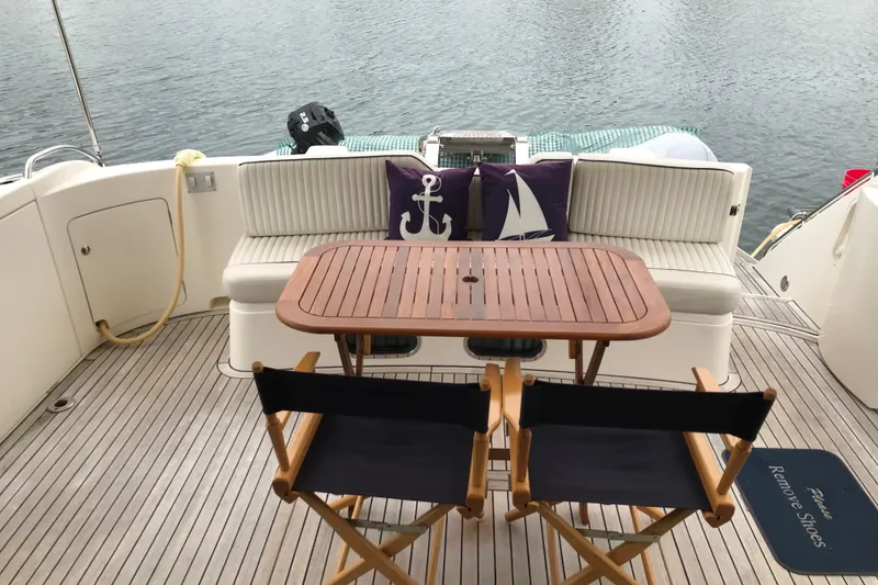 Slide: The Image of Luxury yacht deck with wooden table, chairs, nautical cushions; Princess 1996 model. - 19