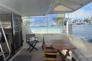 Slide: The Image of 1996 Princess yacht deck with seating, table, and marina view. - 20