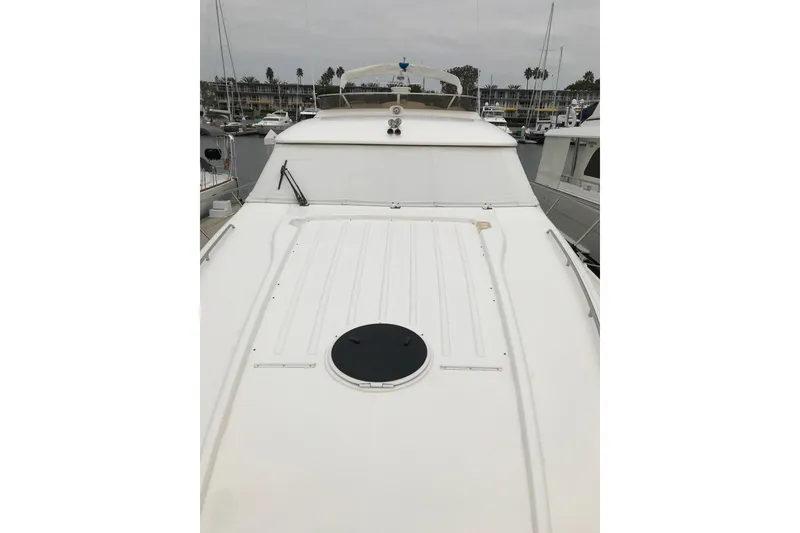 Slide: The Image of 1996 Princess yacht deck view in marina, showcasing sleek design and spacious layout. - 22