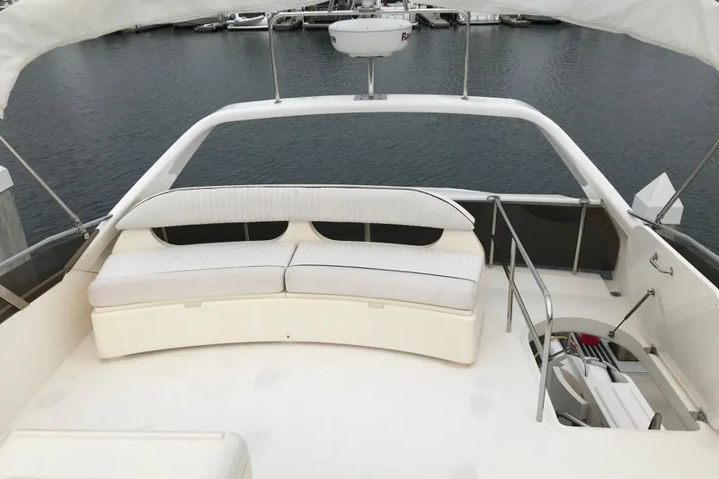 Slide: The Image of 1996 Princess yacht deck with white seating, overlooking marina waters. - 23