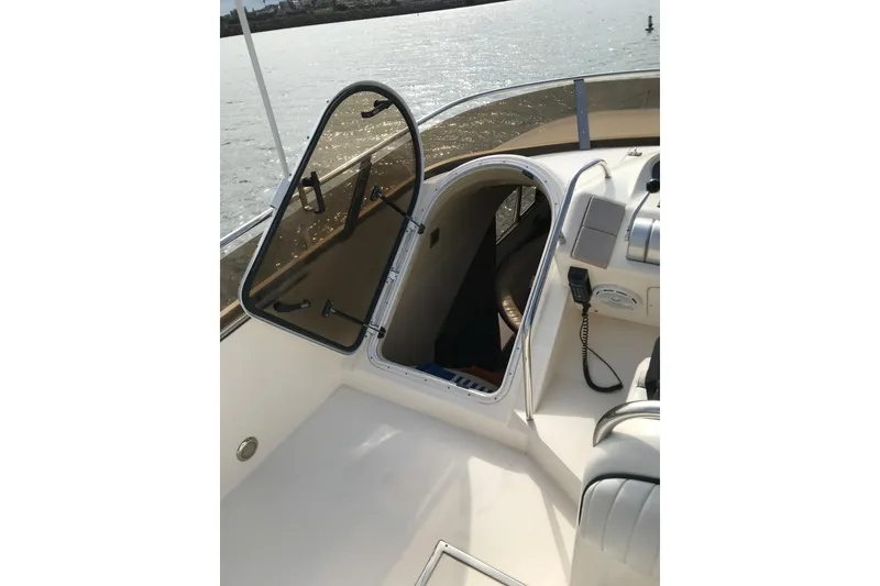 Slide: The Image of 1996 Princess boat interior with open hatch, overlooking calm waters. - 24