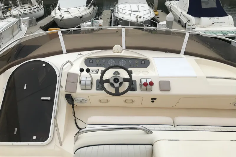 Slide: The Image of Cockpit of a 1996 Princess yacht with steering wheel and control panel. - 25