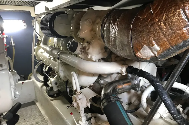 Slide: The Image of Engine room of a 1996 Princess model yacht, showcasing intricate machinery and components. - 26