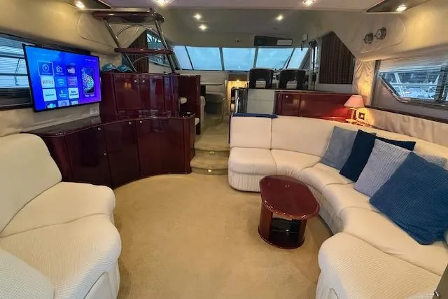 Slide: The Image of Luxurious 1996 Princess yacht interior with plush seating, modern TV, and elegant decor. - 3