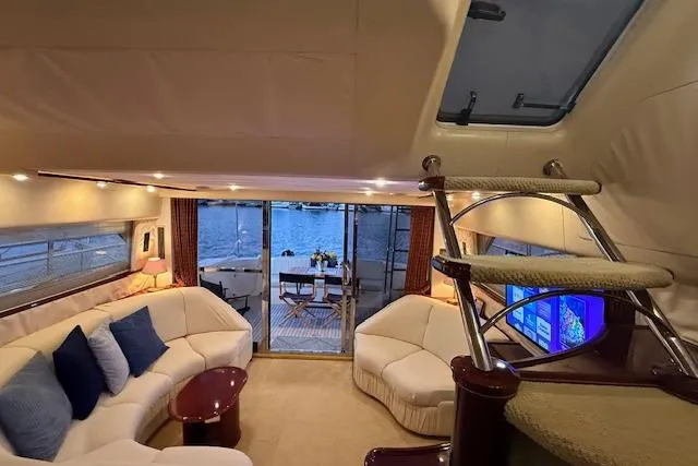 Slide: The Image of Luxurious 1996 Princess yacht interior with elegant seating, staircase, and waterfront view. - 4