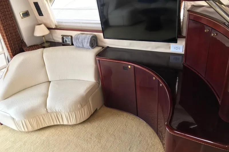 Slide: The Image of Luxurious 1996 Princess yacht interior with cream sofa, TV, and elegant wood cabinetry. - 5