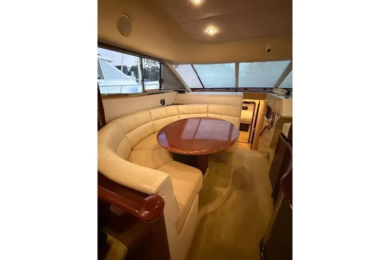 Slide: The Image of Luxurious interior of a 1996 Princess yacht with curved seating and wooden table. - 7
