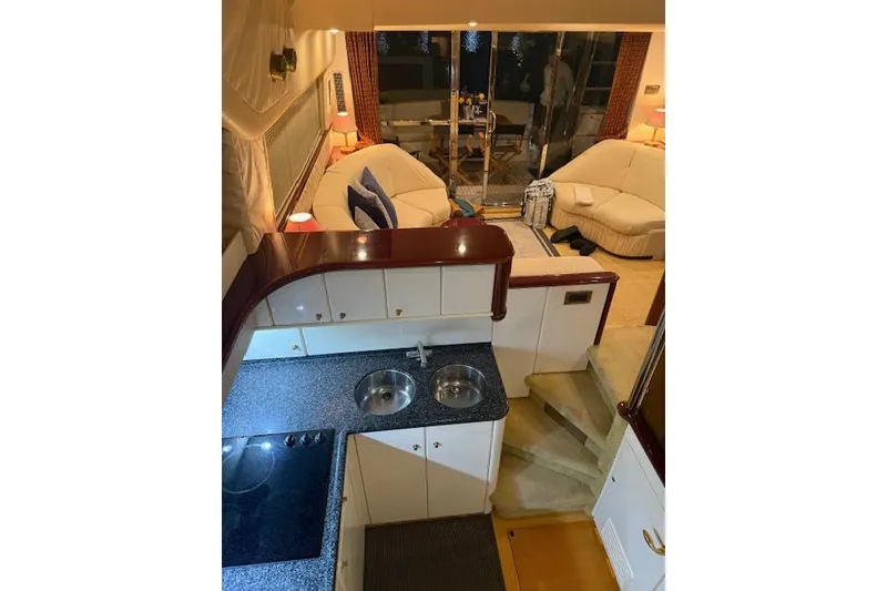 Slide: The Image of Luxurious interior of a 1996 Princess yacht with modern kitchen and cozy seating area. - 8