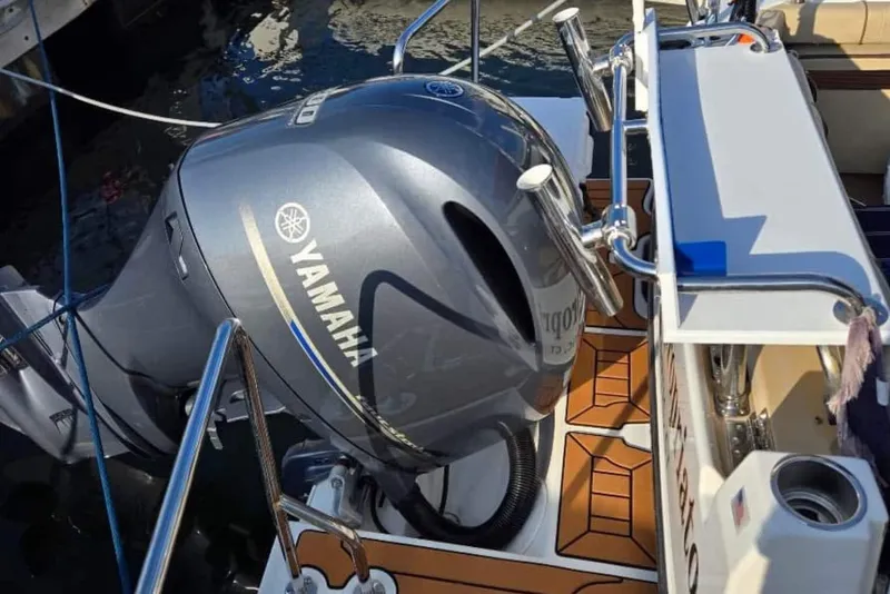 Slide: The Image of Yamaha outboard motor on 2019 Ranger Tugs R-23 boat, docked with fishing rod holders. - 10