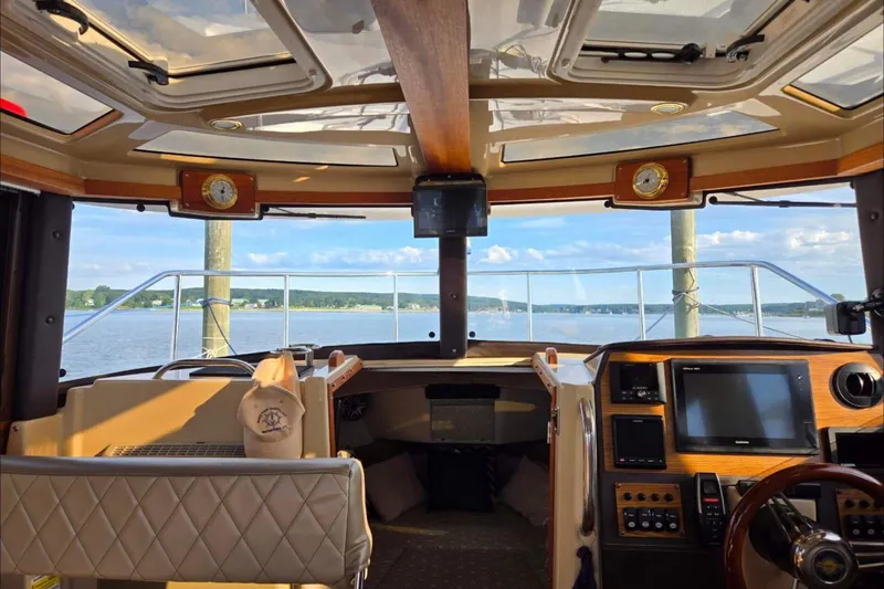 Slide: The Image of Interior view of 2019 Ranger Tugs R-23 boat cockpit with scenic water backdrop. - 3