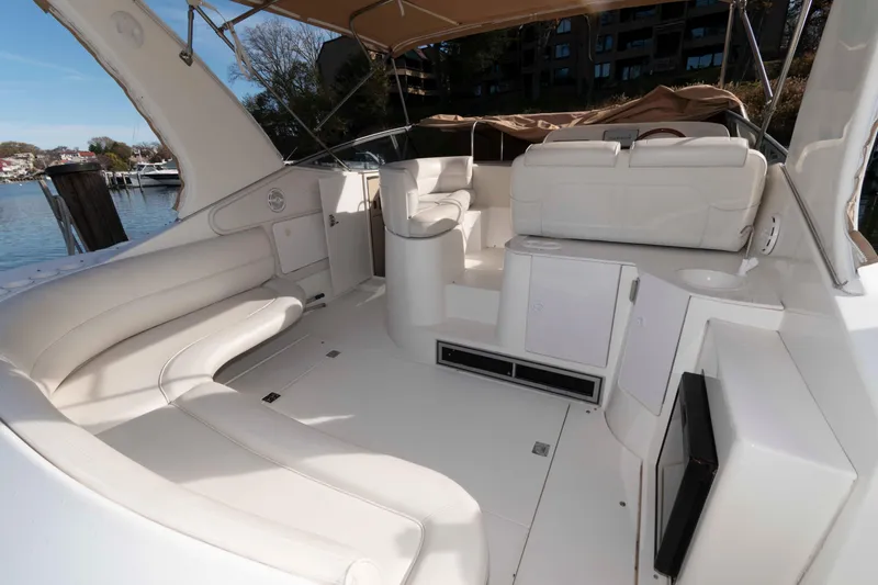 Slide: The Image of 1999 Cruisers Yachts 3575 Express interior with white seating and open deck area. - 2