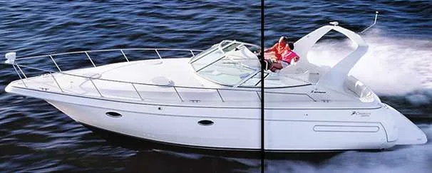 The Image of 1999 Cruisers Yachts 3575 Express docked in a serene marina setting. - 0