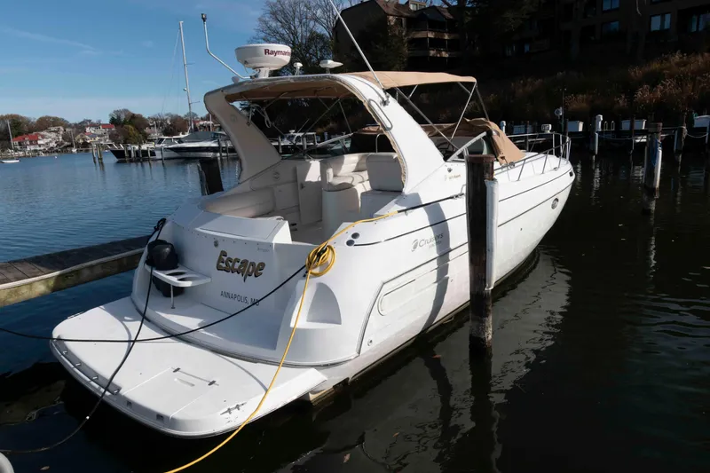 Slide: The Image of 1999 Cruisers Yachts 3575 Express docked in a marina, rear view. - 1