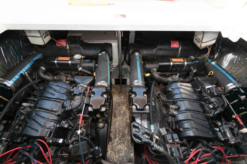 Slide: The Image of Engine compartment of a 1999 Cruisers Yachts 3575 Express, showcasing dual engines and components. - 16