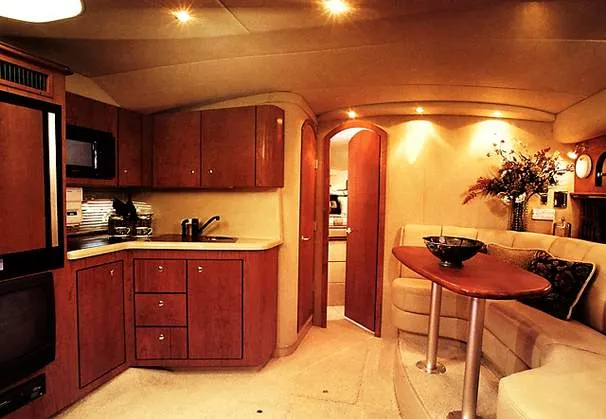 Slide: The Image of 1999 Cruisers Yachts 3575 Express cockpit with white seating and steering console. - 4