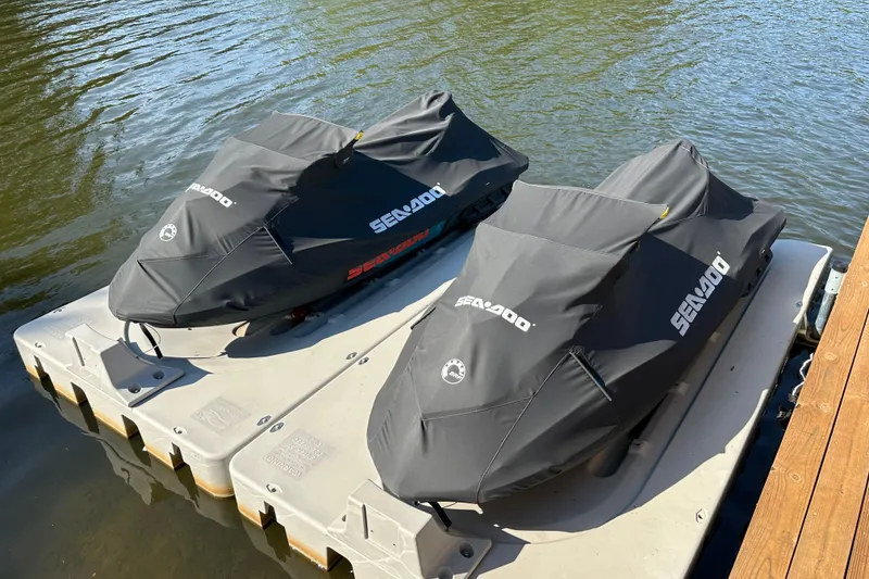 Slide: The Image of Two covered 2019 Sea-Doo Wake 155 jet skis on a floating dock. - 4