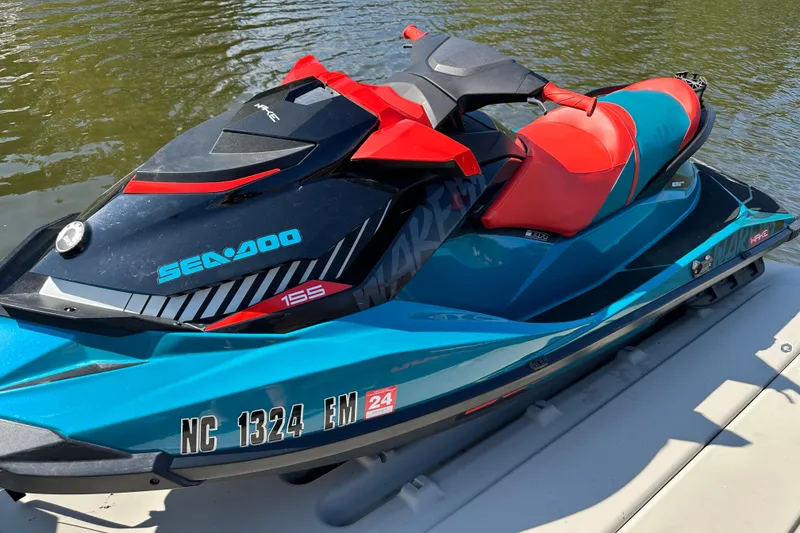 Slide: The Image of 2019 Sea-Doo Wake 155 jet ski on water, featuring vibrant red and blue design. - 5
