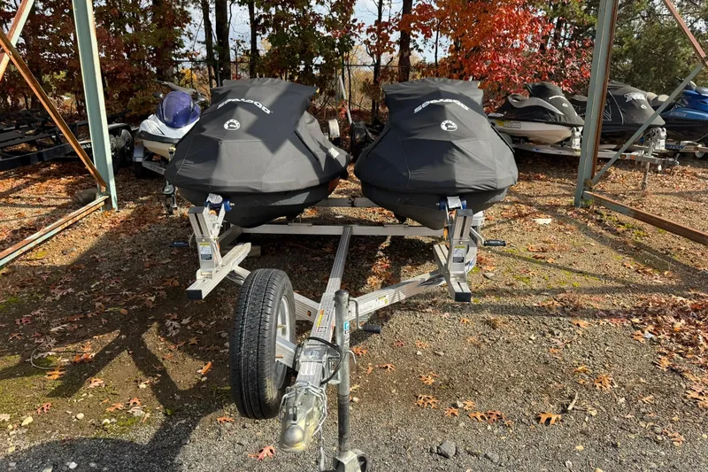 Slide: The Image of Covered 2019 Sea-Doo Wake 155 jet skis on a trailer in a wooded area. - 9