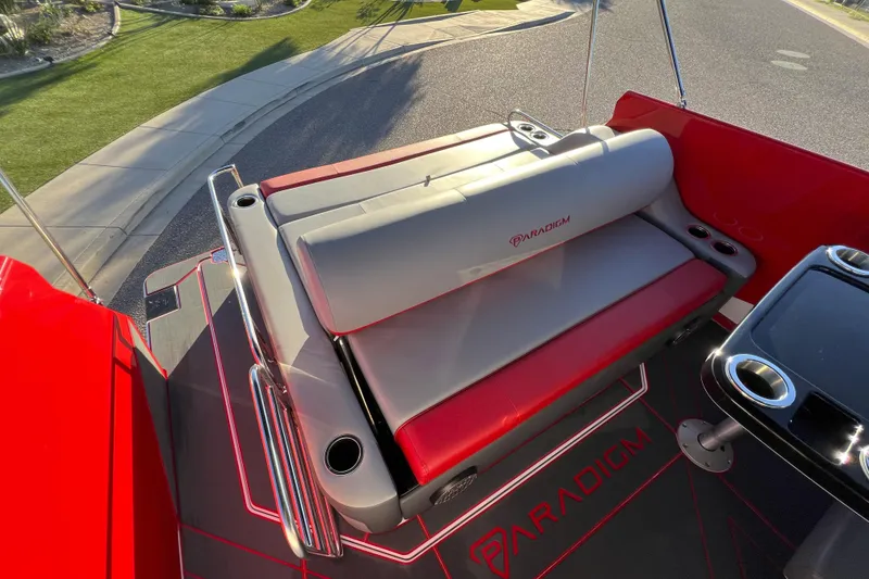 Slide: The Image of 2024 Paradigm Damascus 296 Surf boat interior with red and gray seating and cup holders. - 5