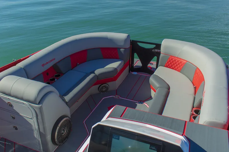 Slide: The Image of Luxurious seating on 2024 Paradigm Damascus 296 Surf boat, featuring red and gray upholstery. - 9