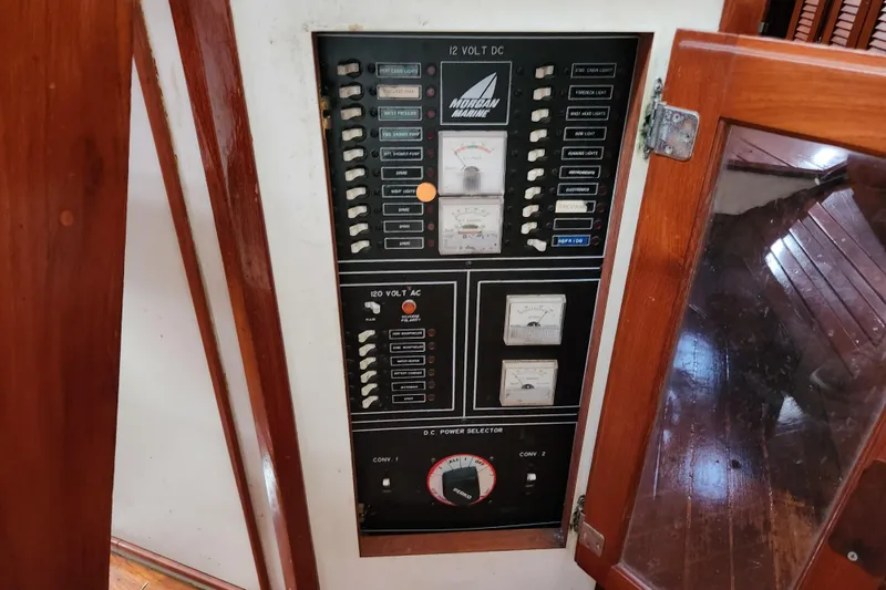 Slide: The Image of Electrical panel of a 1990 Catalina/Morgan 44 Center Cockpit sailboat, featuring switches and gauges. - 10