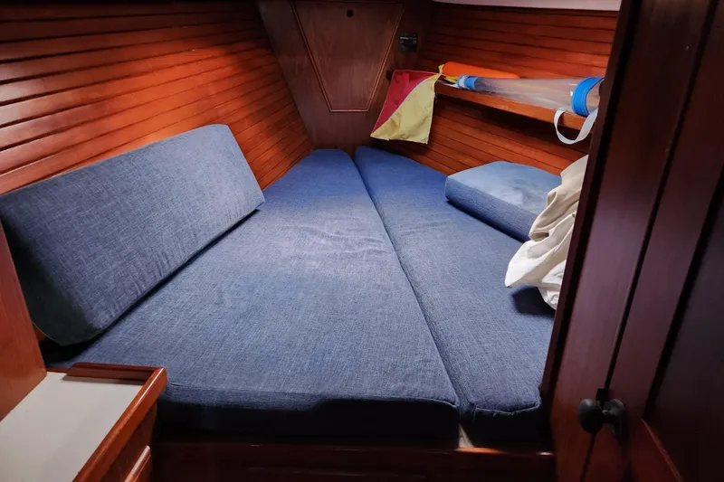 Slide: The Image of Cozy cabin interior of 1990 Catalina/Morgan 44 Center Cockpit sailboat with blue cushions. - 12