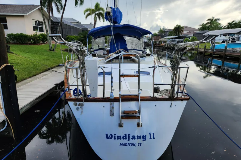 Slide: The Image of 1990 Catalina/Morgan 44 Center Cockpit sailboat docked in a serene marina setting. - 16