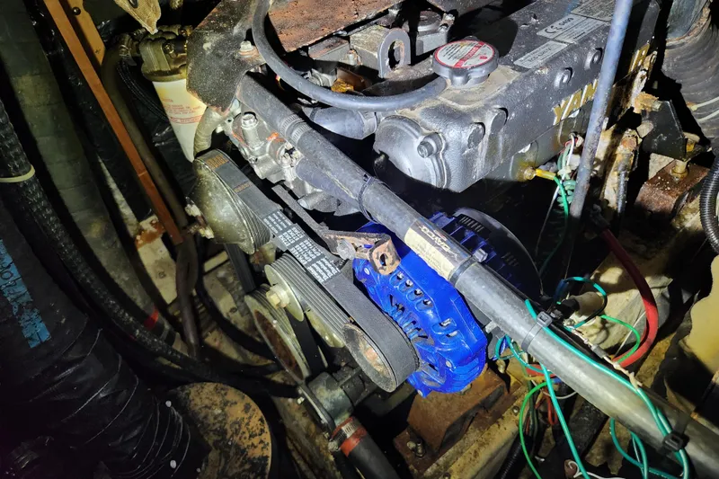 Slide: The Image of Engine compartment of a 1990 Catalina/Morgan 44 Center Cockpit sailboat, featuring mechanical components. - 18