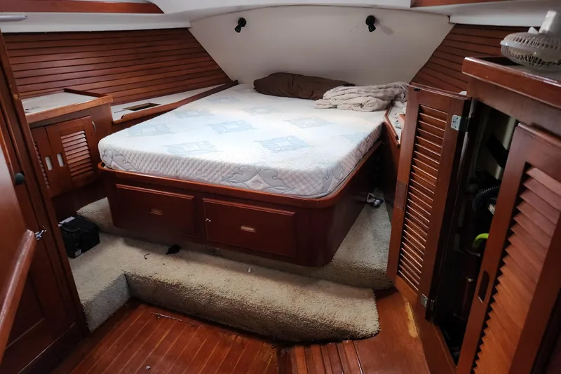 Slide: The Image of Cozy cabin interior of 1990 Catalina/Morgan 44 Center Cockpit sailboat with bed and wooden furnishings. - 21