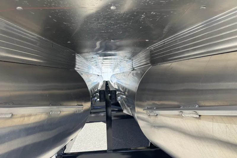 Slide: The Image of Underneath view of a 2025 Paradigm 27SST trailer, showcasing its sleek metal construction. - 10