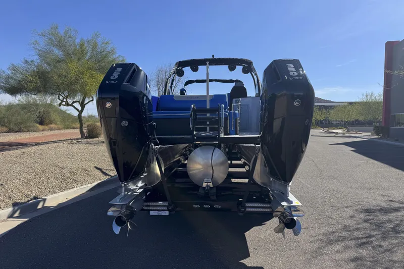 Slide: The Image of 2025 Paradigm 27SST boat with dual outboard motors on a sunny day. - 14