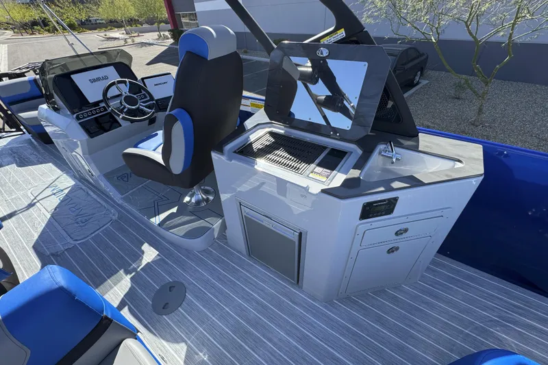 Slide: The Image of Paradigm 27SST 2025 boat interior with steering console and kitchenette setup. - 3