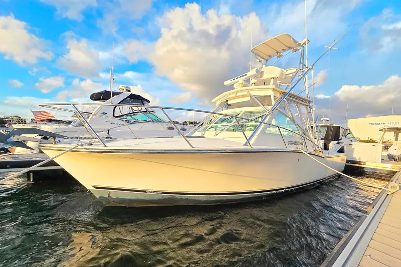 The Image of 2007 Carolina Classic 28 Express boat docked under a vibrant sky. - 0
