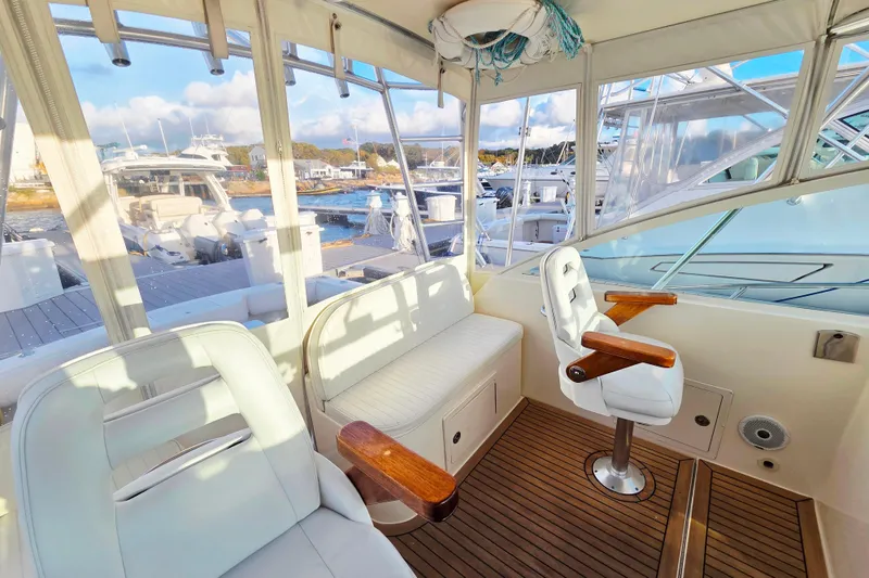 Slide: The Image of Interior of 2007 Carolina Classic 28 Express boat with seating and marina view. - 10