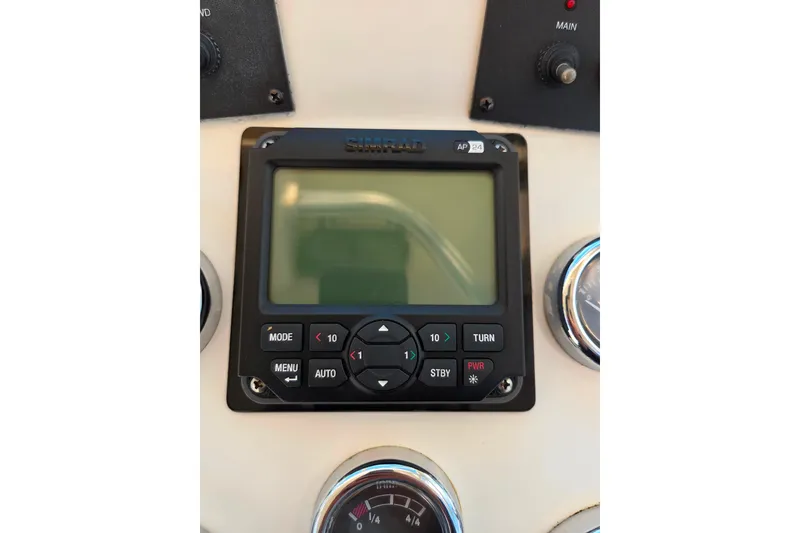 Slide: The Image of Simrad AP24 autopilot control on 2007 Carolina Classic 28 Express boat dashboard. - 13
