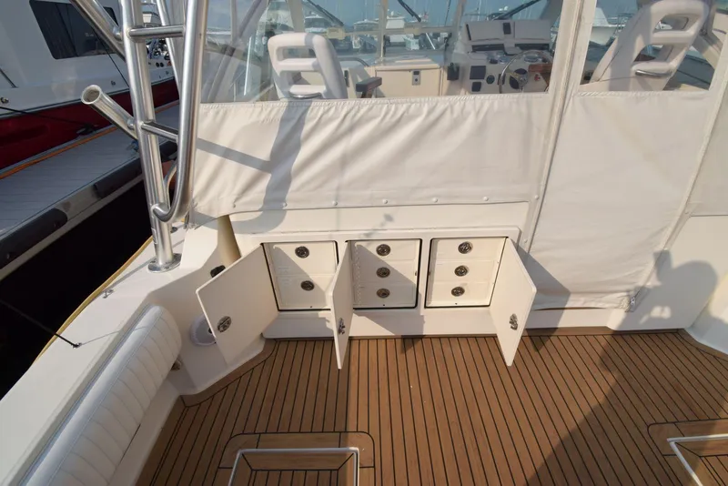 Slide: The Image of 2007 Carolina Classic 28 Express boat with open storage compartments on teak deck. - 15