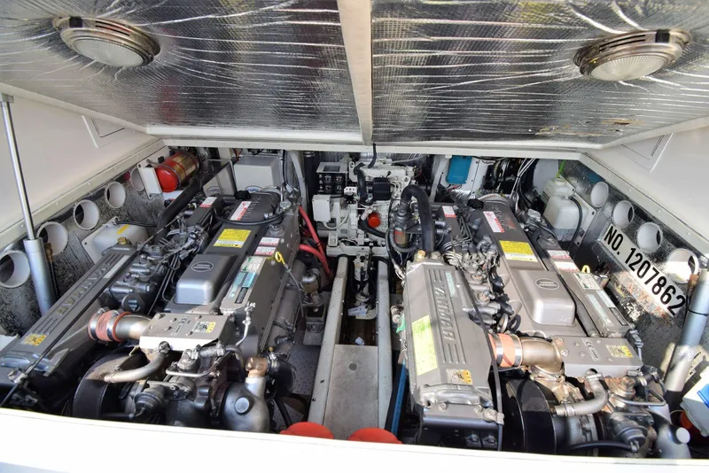 Slide: The Image of Engine compartment of a 2007 Carolina Classic 28 Express boat, showcasing dual engines. - 20