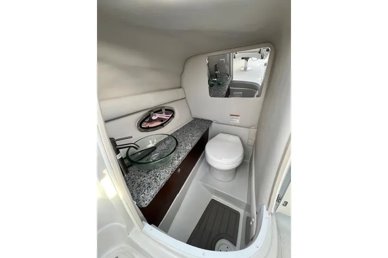 Slide: The Image of 2021 Crownline 265 SS boat interior bathroom with modern sink and toilet. - 10