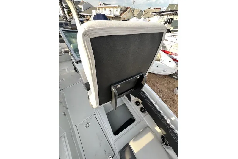 Slide: The Image of 2021 Crownline 265 SS boat interior with open storage compartment and seating. - 13