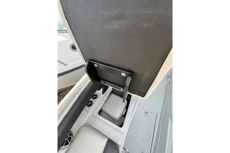 Slide: The Image of 2021 Crownline 265 SS boat interior with storage compartment and seating. - 14