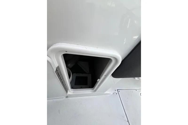 Slide: The Image of 2021 Crownline 265 SS boat storage compartment, white interior detail. - 18