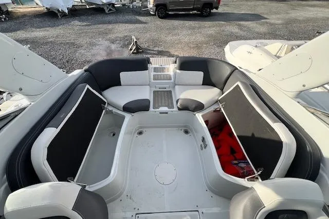 Slide: The Image of 2021 Crownline 265 SS boat interior with spacious seating and storage compartments. - 19