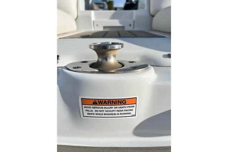 Slide: The Image of 2021 Crownline 265 SS boat cleat with safety warning label. - 21