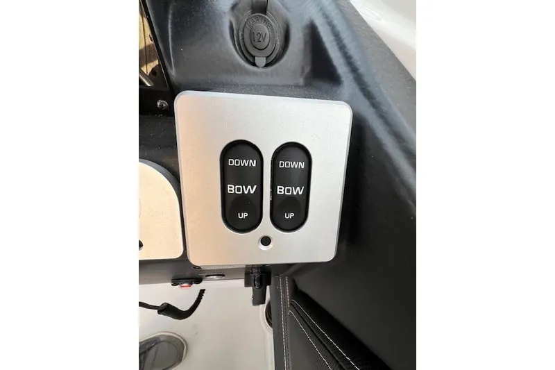 Slide: The Image of 2021 Crownline 265 SS boat control panel with bow adjustment switches. - 6