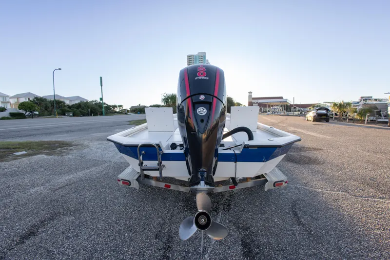 Slide: The Image of 2020 Vexus AVX1980CC boat with outboard motor on a trailer in a parking lot. - 12