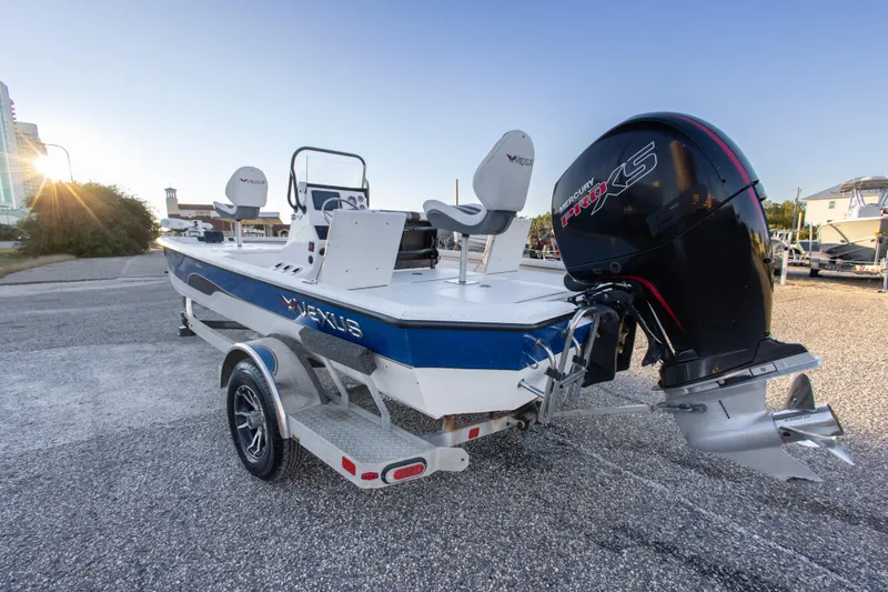 Slide: The Image of 2020 Vexus AVX1980CC boat with Mercury Pro XS engine, parked on a trailer. - 13