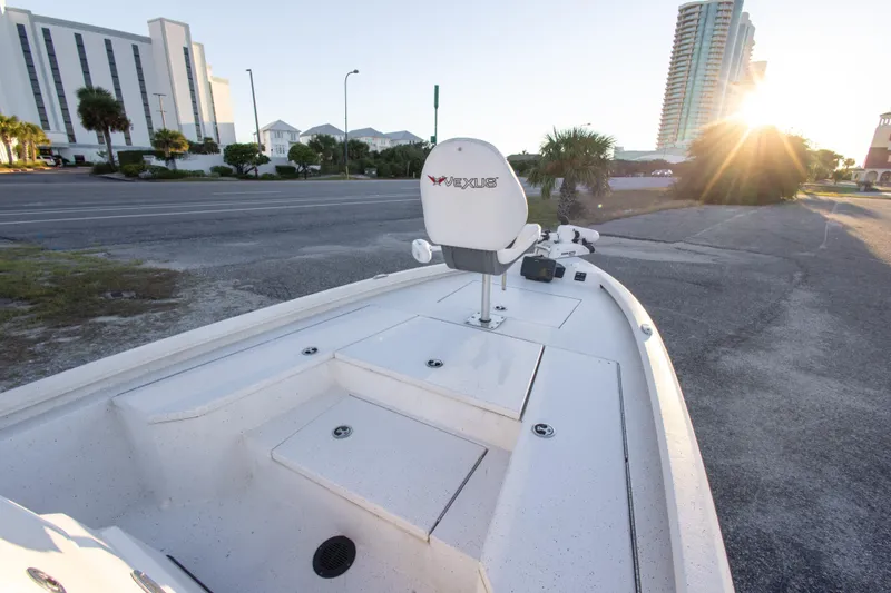 Slide: The Image of 2020 Vexus AVX1980CC boat with seating, parked near a road at sunrise. - 20